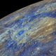 An enhanced-color image of Mercury, highlighting the carbon-rich material associated with impact craters. Image Credit: NASA/JHUAPL/Carnegie Institution of Washington